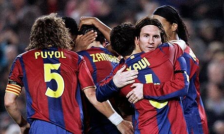 FC Barcelona player Lionel Messi celebrating with team after goal.